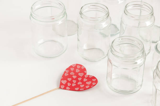 istock Assorted set of glass containers without lids on white background, recycling. Concept of second life to materials, various uses for glass vials. 1473271805