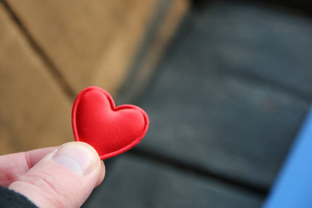 istock Human hand holding red toy heart. Valentine's Day idea. 1473272059