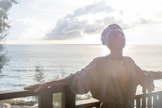 istock Woman enjoys her balcony at sunset 1473272580