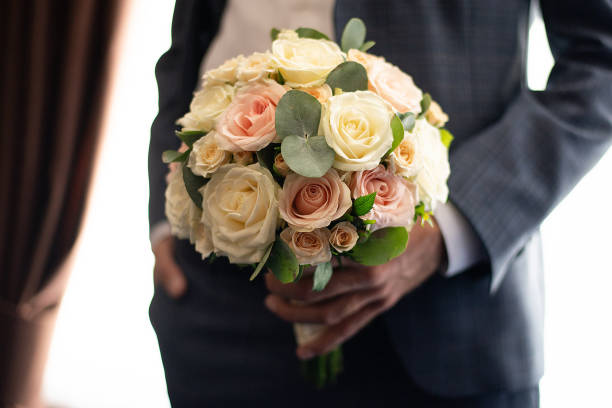 istock man with a bouquet in his hands 1473272919