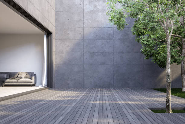 A large empty wooden terrace, loft style, between the living room and the garden 3d render A large empty wooden terrace, loft style, between the living room and the garden 3d render, there are gray plank floor and blank concrete wall for copy space. apartment balcony garden stock pictures, royalty-free photos & images