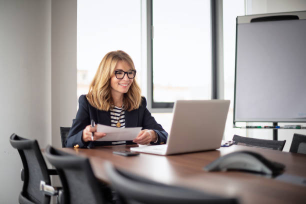 istock Executive businesswoman having video call while sitting in a modern office 1473274499
