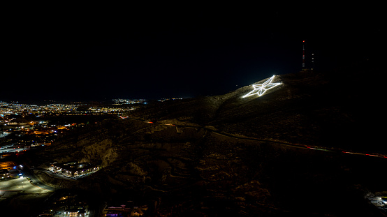 Illuminated star signifying the lonestar on a hill in El Paso, Texas
