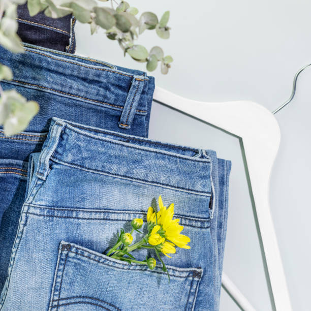 istock Jeans with flower and hanger on blue background 1473276723