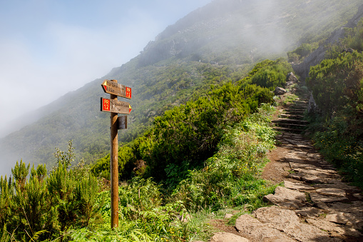 Wooden road destination sign near Pico Ruivo at the highest walking tourist path of Madeira island