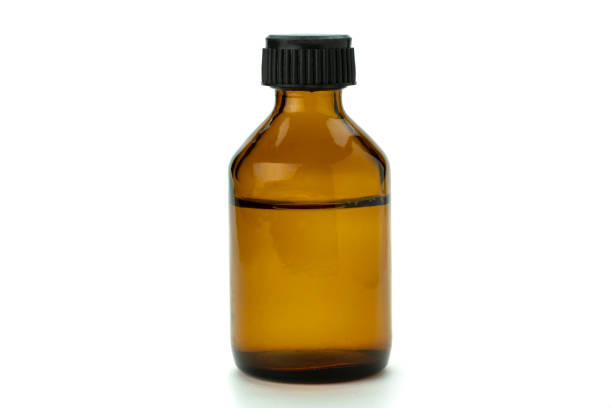 istock Brown glass medical bottle with liquid and black plastic cap 1473280627