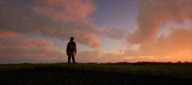 istock Boy with backpack in pasture in countryside under a blue cloudy sky during sunset. 3D rendering. 1473282776