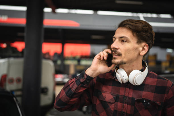 istock one man use mobile phone talk make a call at parking lot alone in day 1473284074