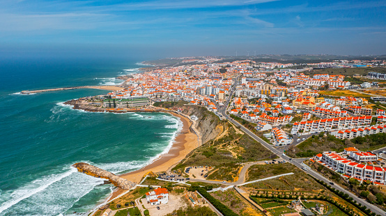 Drone aerial view over beaches, coastlines in Ericeira, Portugal, on summer sunny day. Aerial view to the Beautiful European touristic town. Beautiful cityscape with skyline, ocean rocky shore