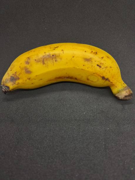 istock One ripe banana in the black background 1473284817