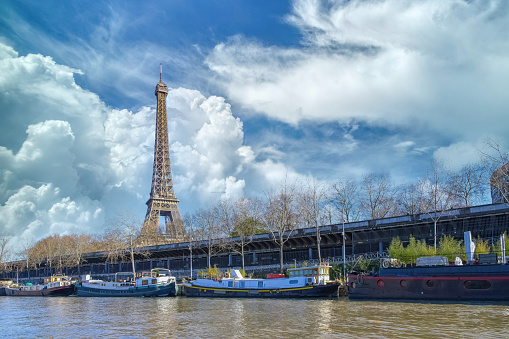 Paris, the Eiffel Tower, with houseboats on the Seine