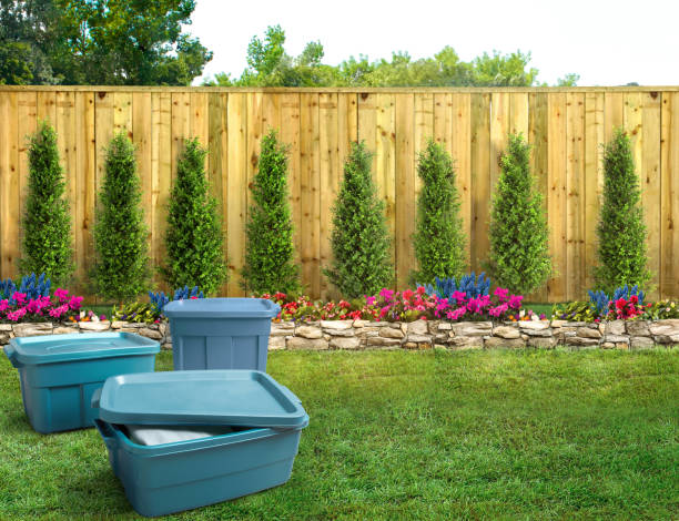 istock Blue plastic storage totes in a backyard with a fence 1473294929