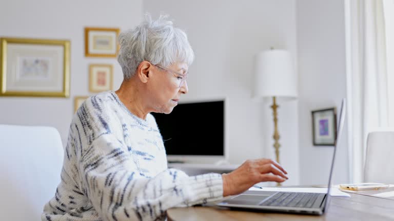 Senior woman using a laptop computer at home