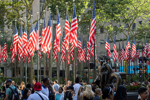 New York, NY, USA - July 2, 2022: Visitors to the Rockefeller Center decorated for the Fourth of July celebration, in Midtown Manhattan, New York City.