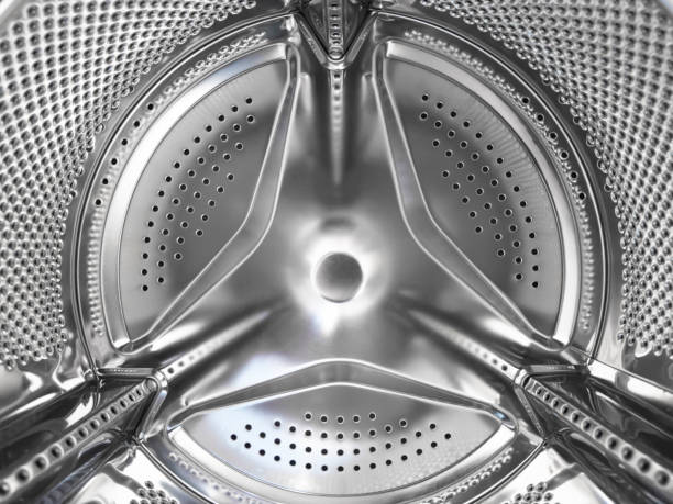 istock Washing machine drum close up. Washing machine background. Inside the washing machine. Metal washing machine drum. Perforated shiny metal 1473297692