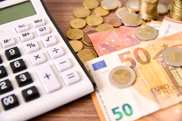 istock calculator and money on the wooden table 1473298144