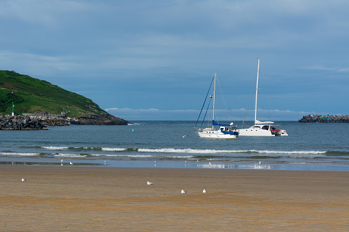 Two yachts anchored in the bay at Jetty Beach in Coffs Harbour, New South Wales, Australia.