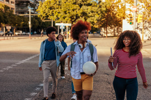istock Happy students walking in city. 1473303004