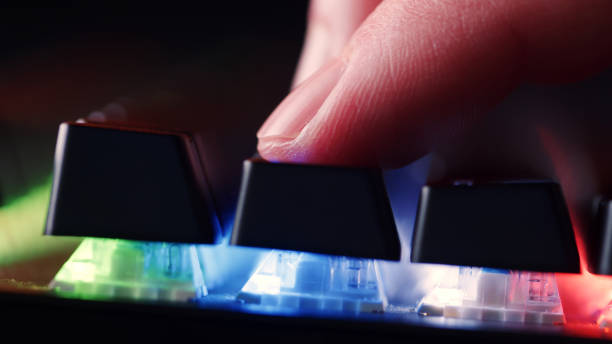 istock Human finger is on the keys on the computer keyboard, close up view. Finger  on the gaming keyboard key with led light, macro shot. Low angle view with a soft focus. 1473304550