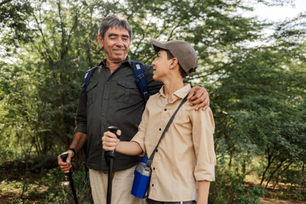 istock Active senior hiking in the woods with his grandson 1473305735