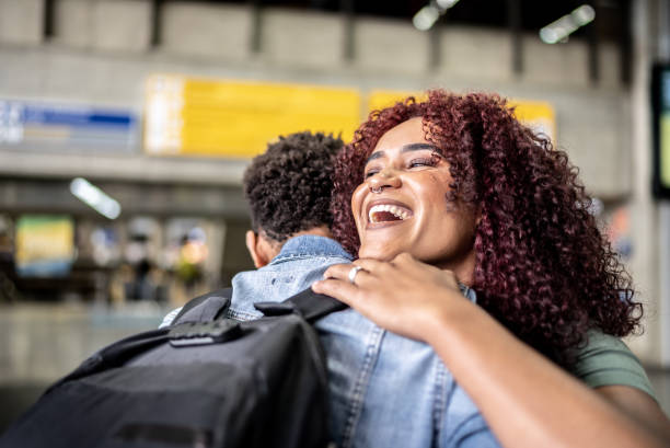 istock Friends embracing at the airport 1473306596