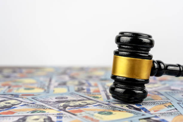 istock Pile of US 100 dollars bills with Gavel 1473306772