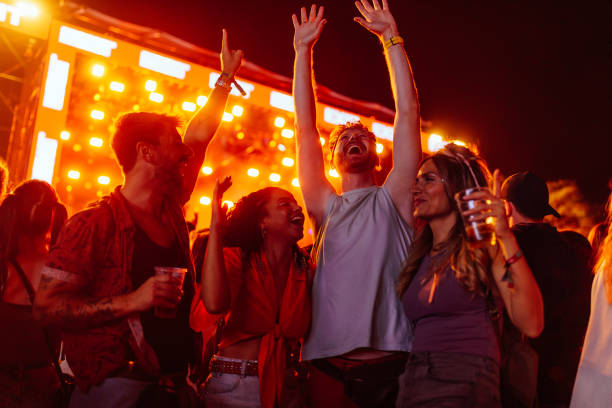 istock cheerful friends dancing at festival 1473307003