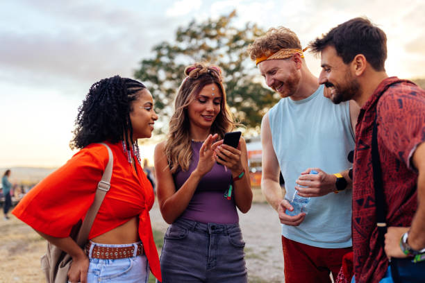 istock Friends looking at dj line up on smartphone 1473307043