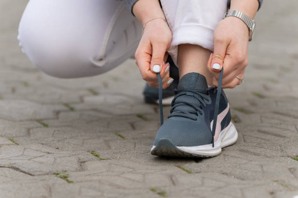 istock Woman tying running shoes 1473307567