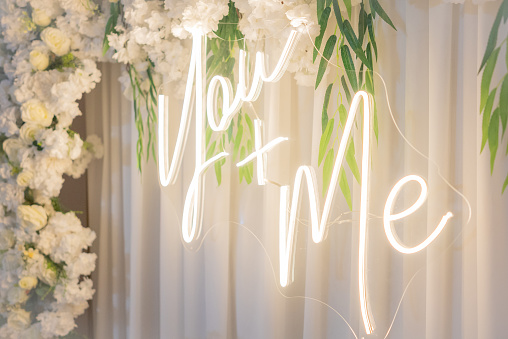 White wedding led sign, you and me, with rose flowers