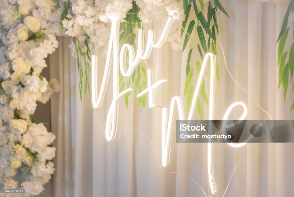 White wedding led sign, you and me, with rose flowers Wedding Reception Stock Photo