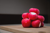 close-up, fresh juicy radish lies in a slide on a wooden board. advertising banner