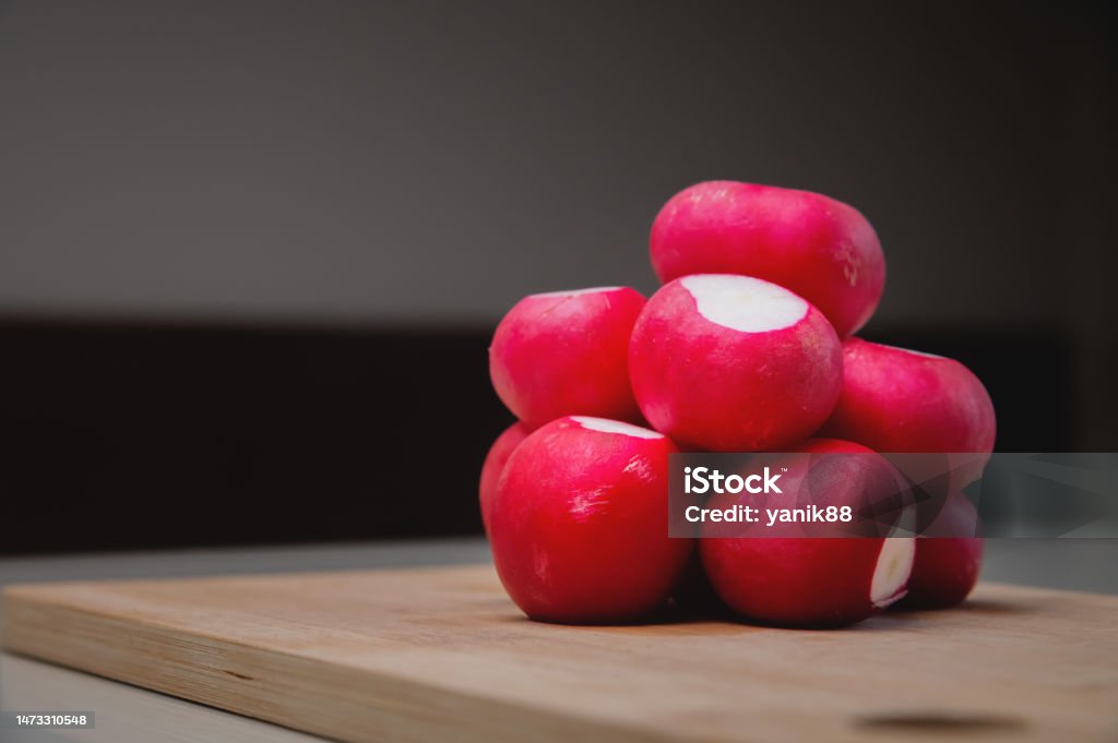 close-up, fresh juicy radish lies in a slide on a wooden board. advertising banner close-up, fresh juicy radish lies in a slide on a wooden board. advertising banner. Radish Stock Photo