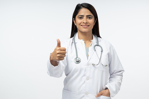 smilind doctor in white uniform showing thumb up