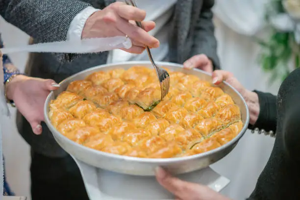 Photo of Close up Bride and Groom Eating Wedding Dessert Baklava