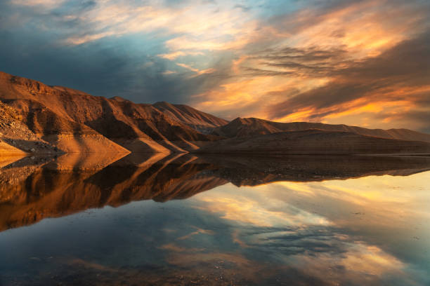 istock Beautiful sunset over the mountains and  lake. Panoramic sunset landscape. 1473314711