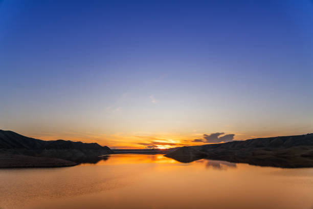 Beautiful sunset over the lake. Panoramic sunset landscape.