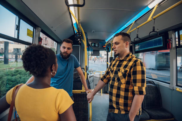 istock Multiracial friends talking while riding a bus in the city 1473315325