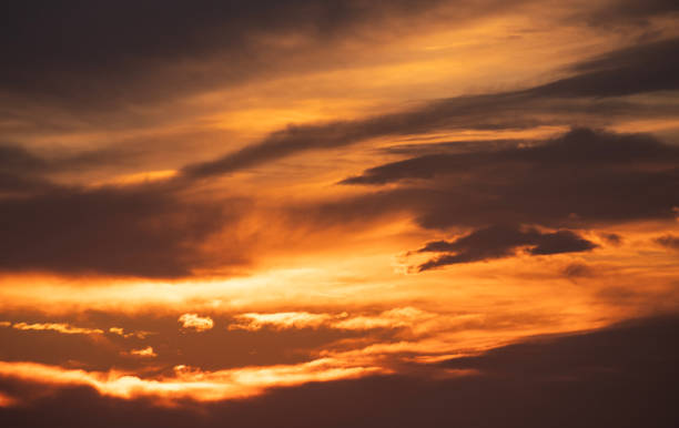 istock Beautiful bright orange sunset sky with dramatic clouds. Sunset sky with clouds background. 1473315868