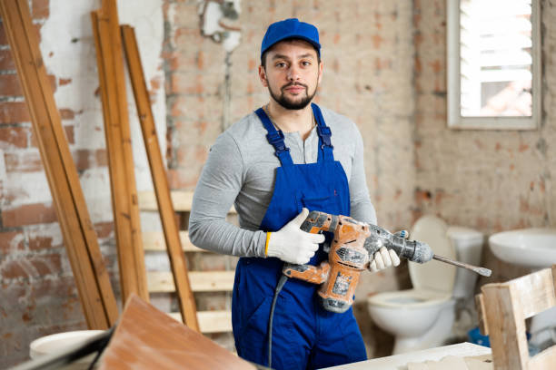 istock Portrait of a builder holding a hammer drill in his hands 1473319885