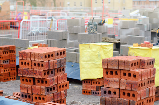 A shot of a female site manager having an on-site meeting with female and male construction workers on a building site.