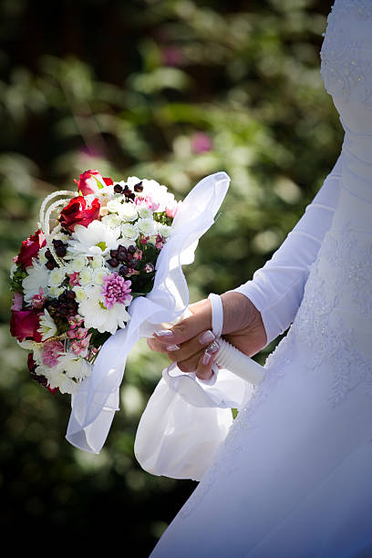 istock Holding wedding bunch of flowers 147332150