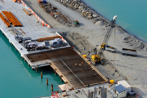 A large crane gets ready to lift more re-bar into some foundations which are being build on in the Napier port, New Zealand.