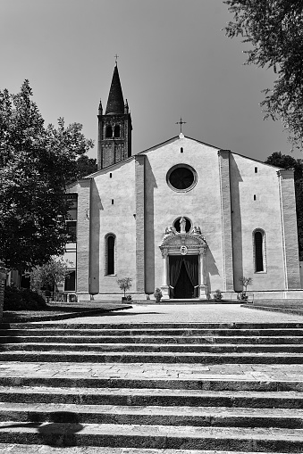 stone steps and facade of the historic church of Parrocchia di Santa Maria Assunta in Monteortone in Italy, monochrome