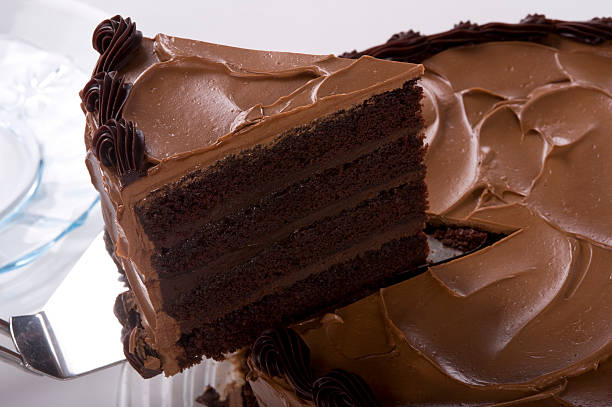 Chocolate Cake Chocolate cake with a slice being taken. chocolate cake stock pictures, royalty-free photos & images