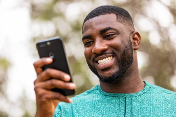 istock Young African millennial using smartphone to check his bank account online 1473328975