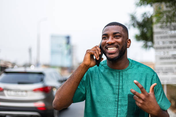 istock Excited young African man talking on smartphone outdoors. 1473329007