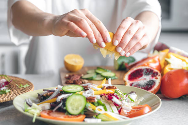 istock A woman makes a fresh vegetable salad, close-up. 1473332017