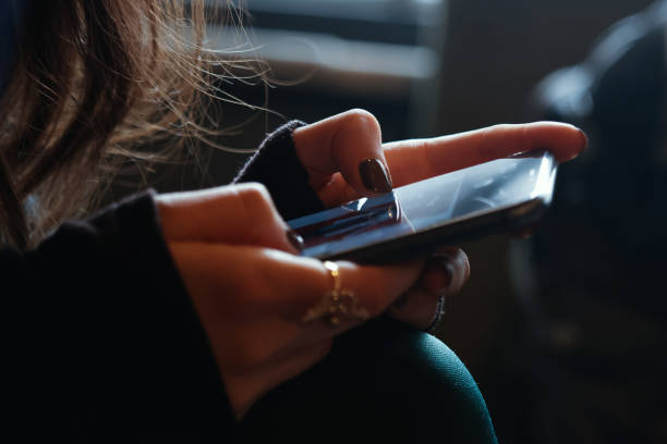 istock Woman holding mobile phone 1473332783