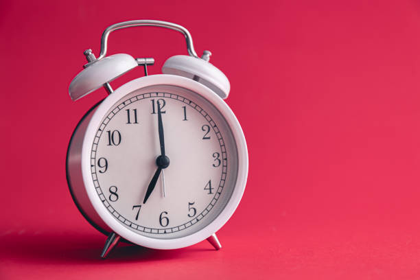 istock White alarm clock on Viva Magenta color background. 1473332934